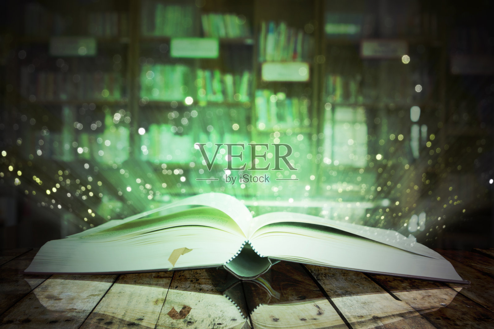 打开魔法书的图像与闪烁的灯光。照片摄影图片