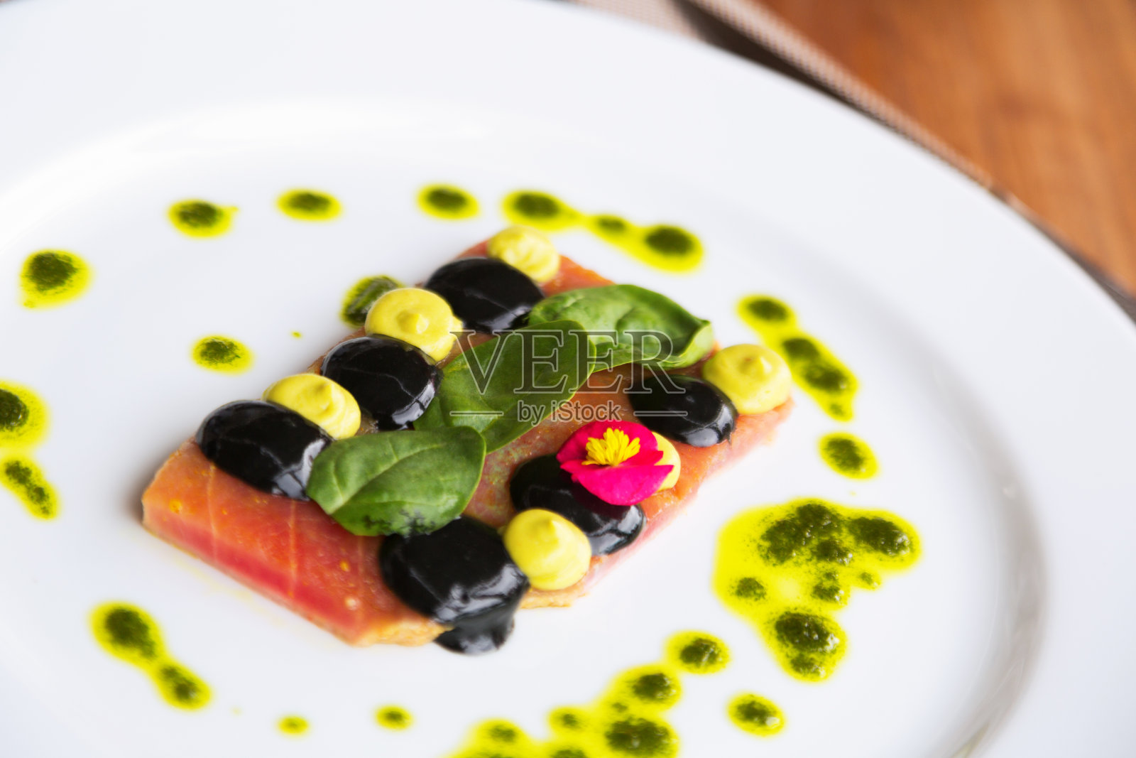 金枪鱼牛排配酱汁在盘子里照片摄影图片