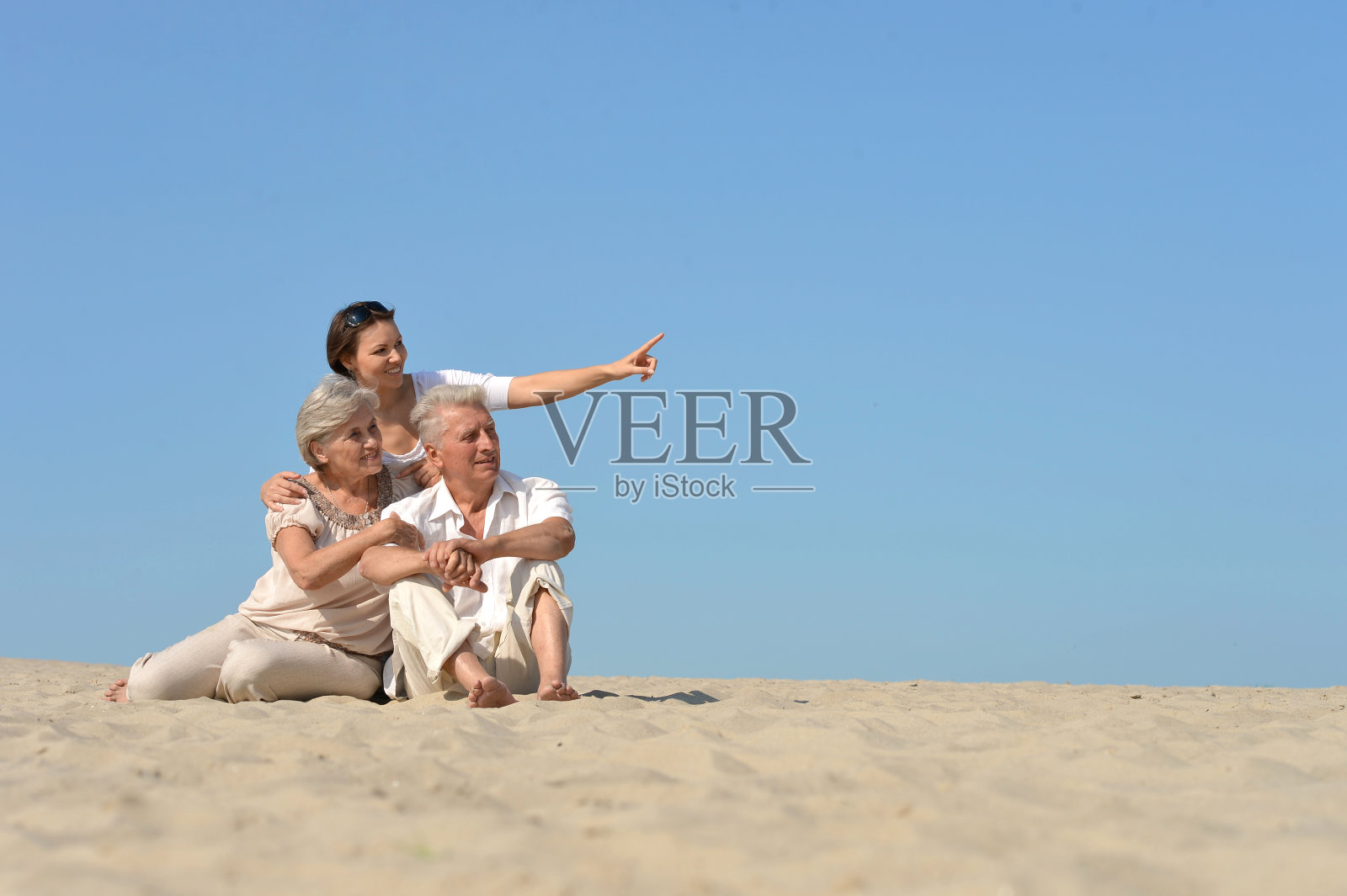 人们坐在沙滩上照片摄影图片