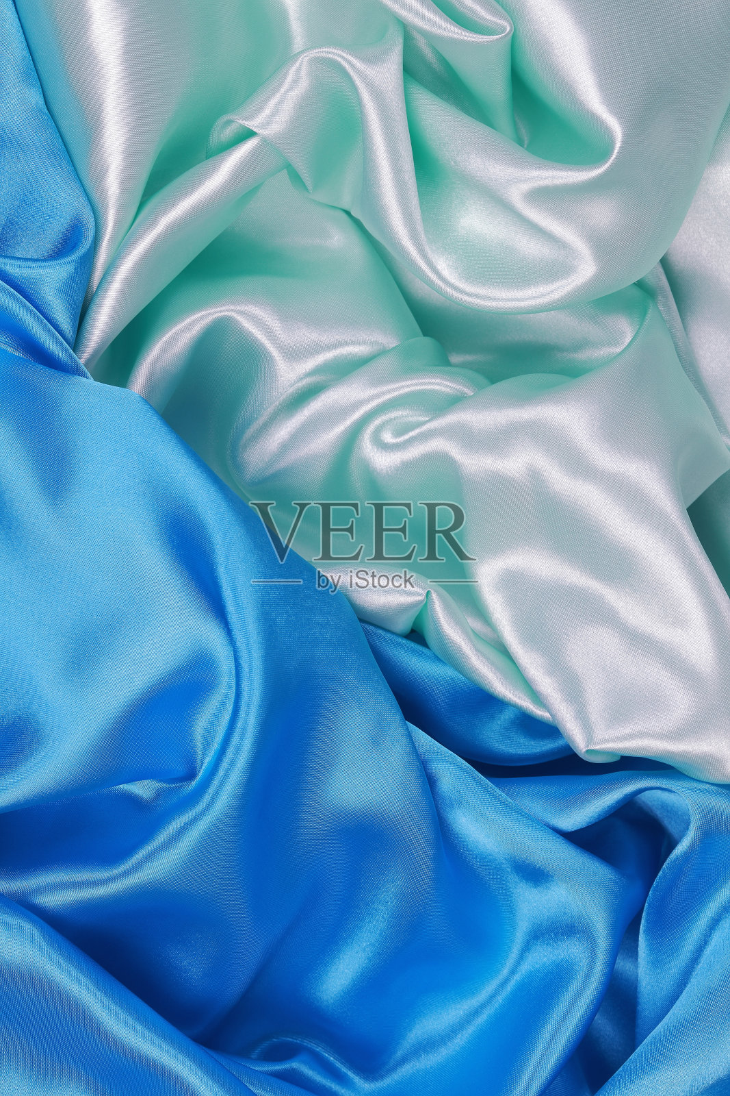 蓝色和浅绿色的波纹抽象背景丝绸布料照片摄影图片