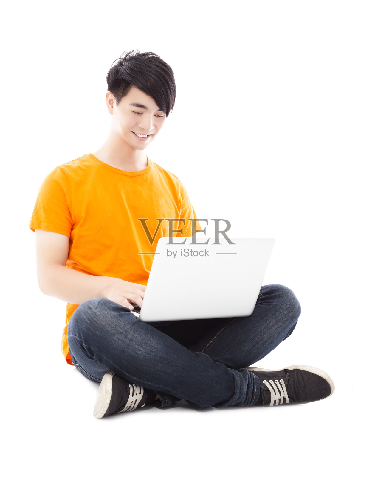 微笑的年轻学生坐在地板上使用笔记本电脑照片摄影图片