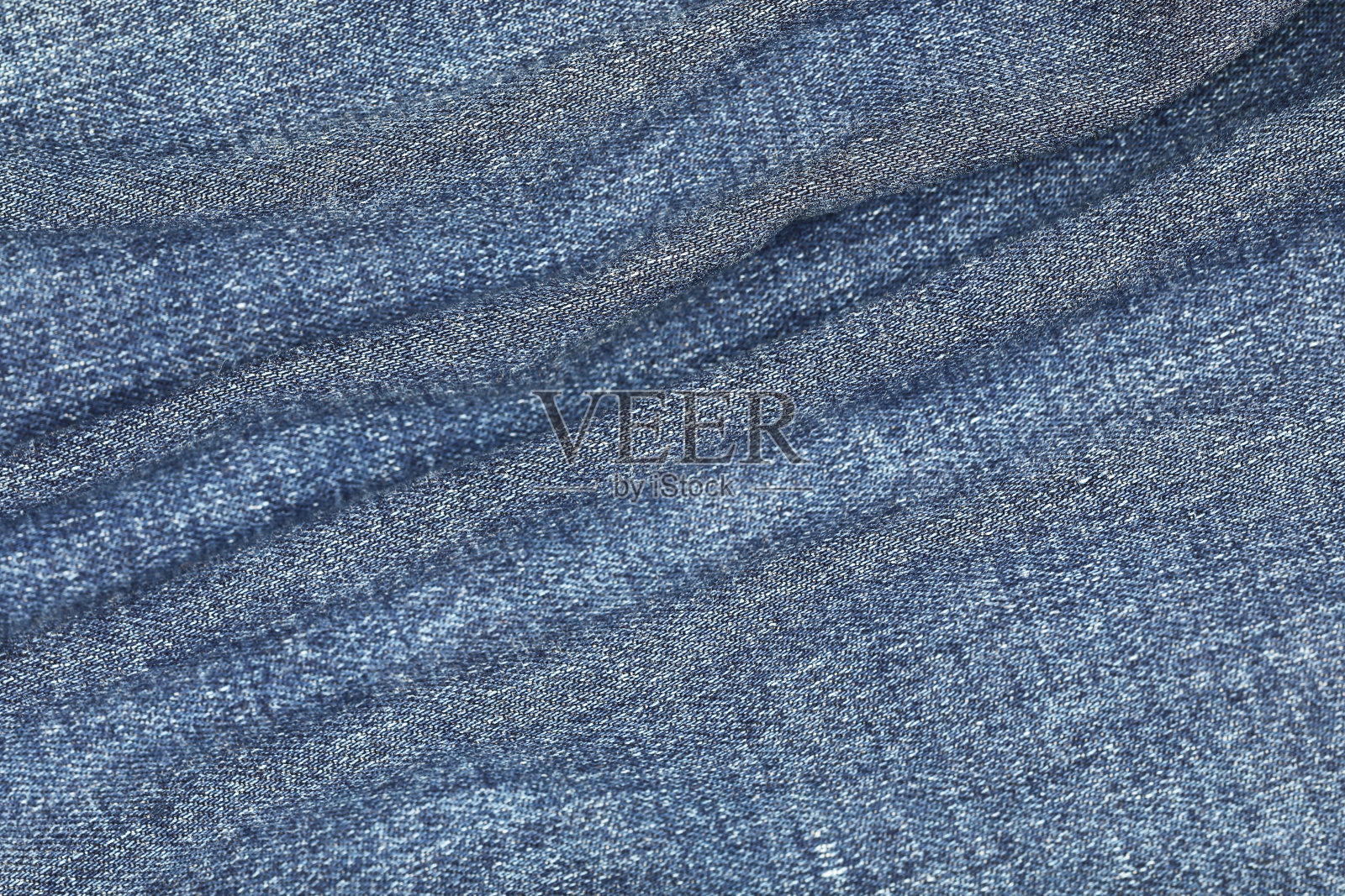 牛仔裤的花纹和背景纹理呈波浪状照片摄影图片