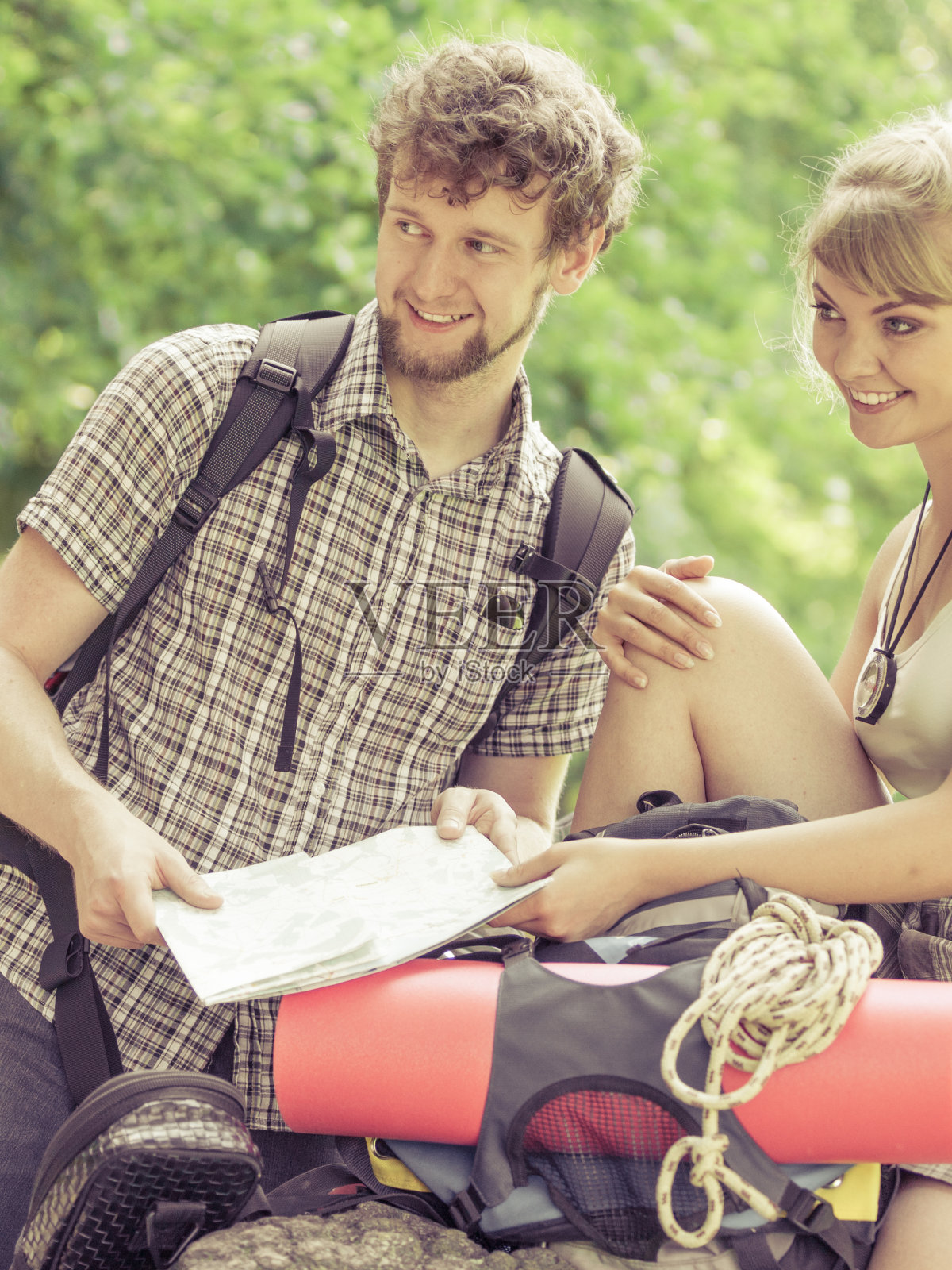 徒步背包夫妇在旅行中阅读地图。照片摄影图片