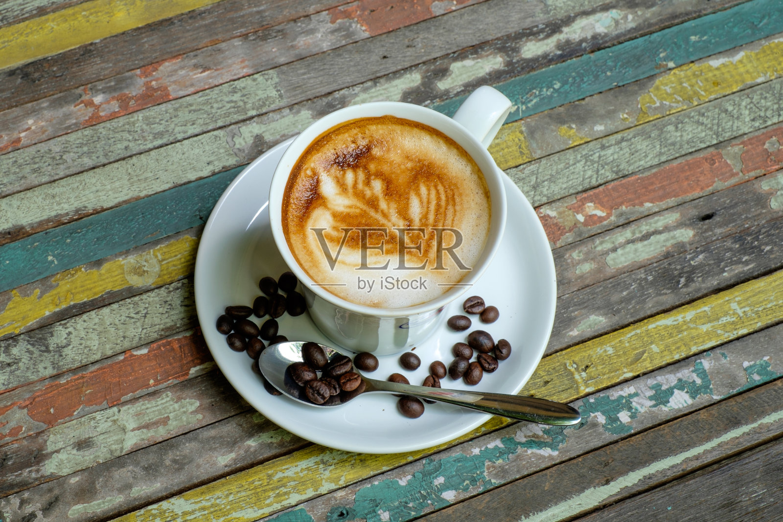 杯子里的咖啡放在彩色桌子的木头上照片摄影图片