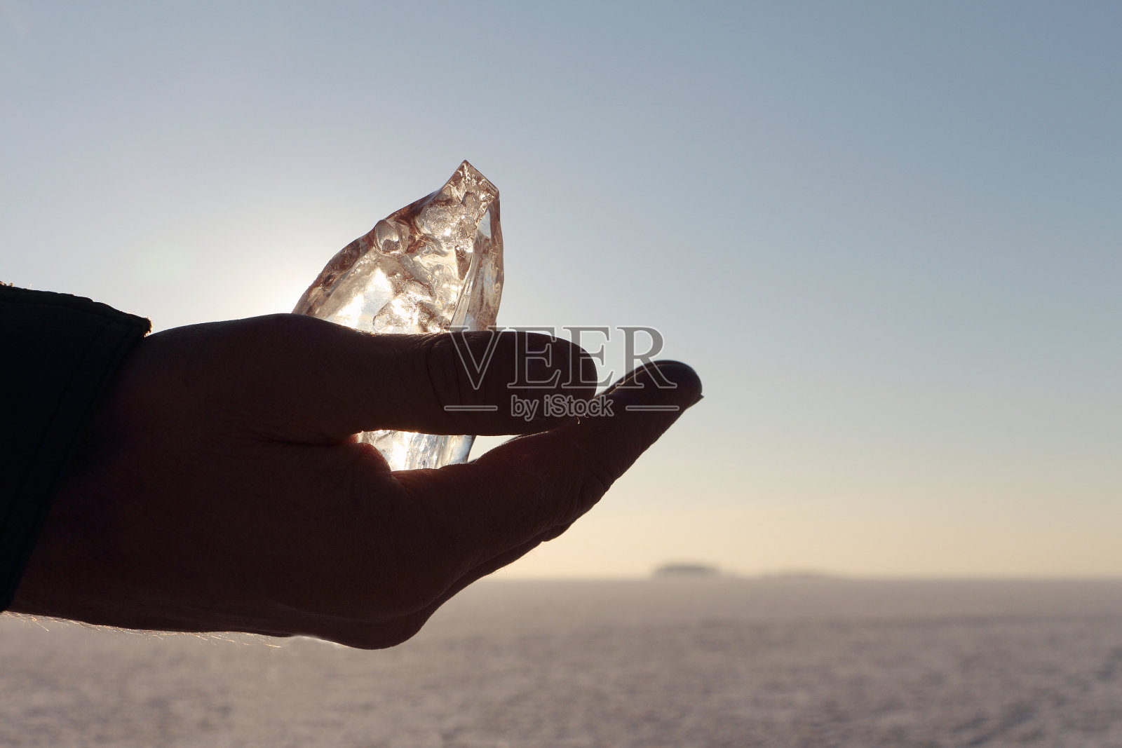冰晶在一个男人的手对着天空照片摄影图片