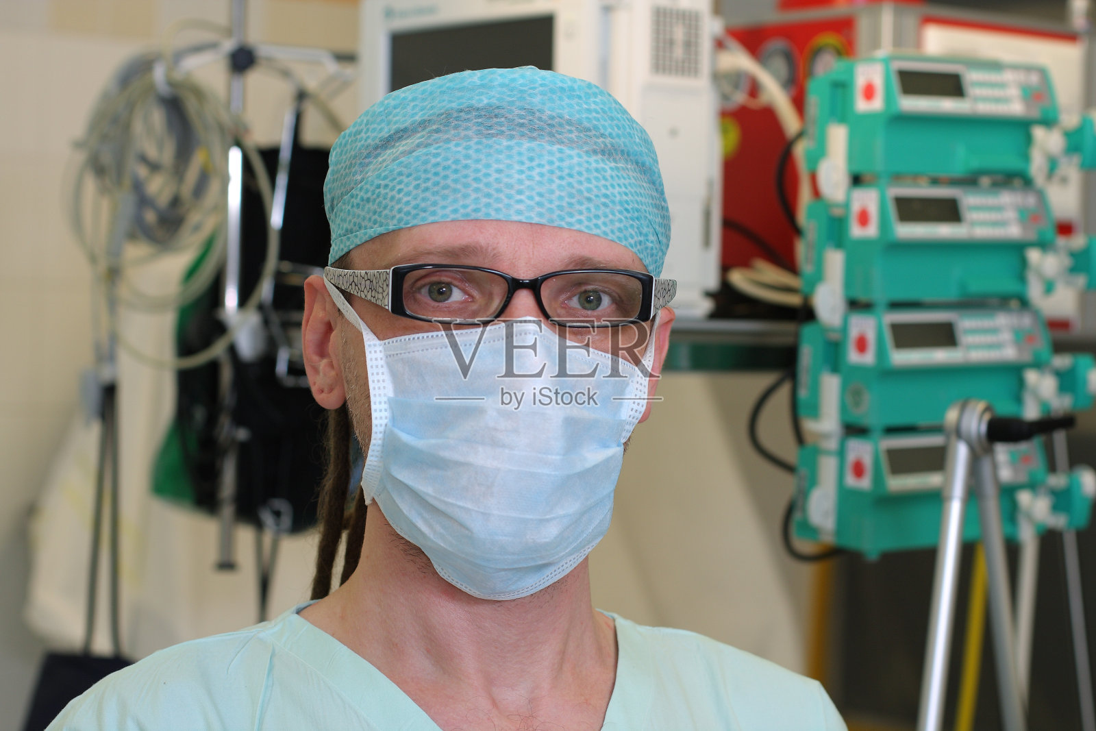 身穿绿色制服的ICU男护士肖像。照片摄影图片