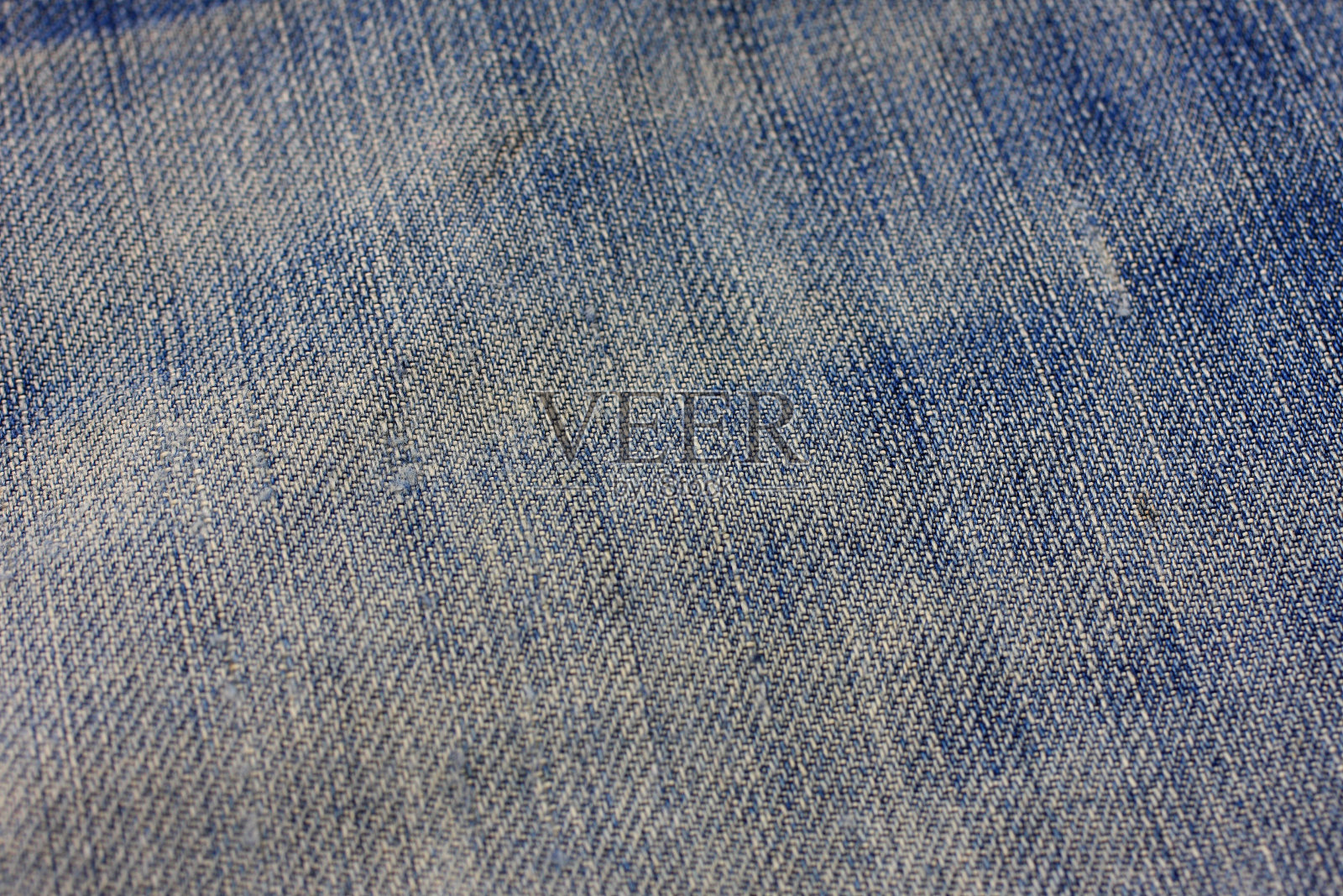 特写牛仔布纺织品的背景。照片摄影图片