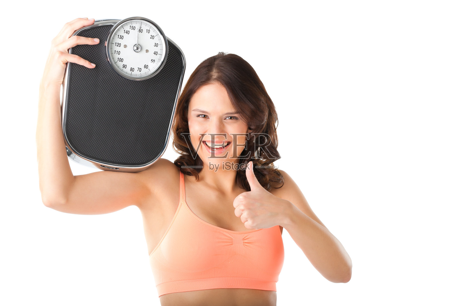 穿着运动服拿着秤的年轻女子照片摄影图片