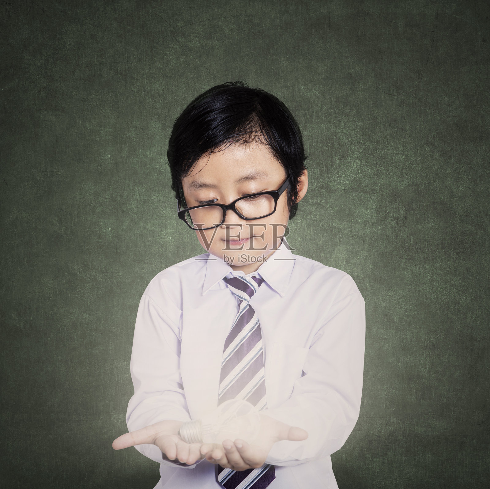 小男孩和一个亮着的灯泡照片摄影图片