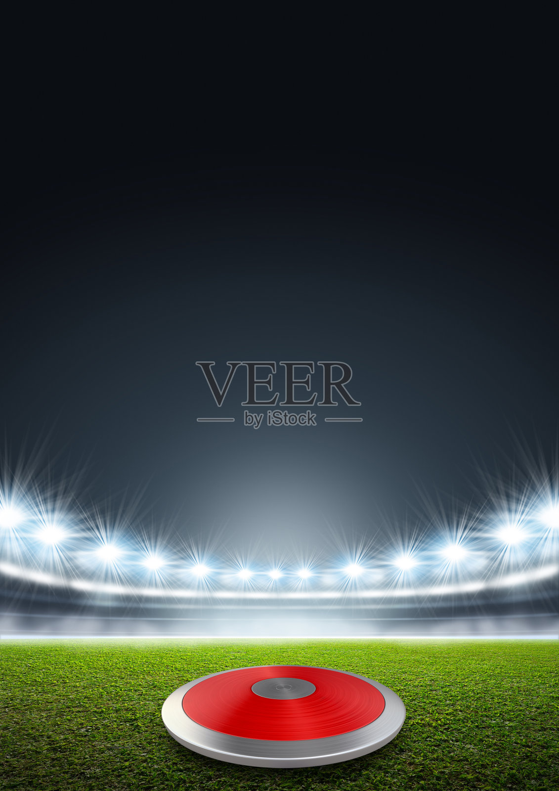 泛光照明的体育场里的铁饼照片摄影图片