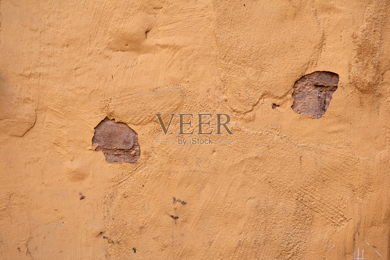 黄色灰泥覆盖的旧墙的纹理照片摄影图片