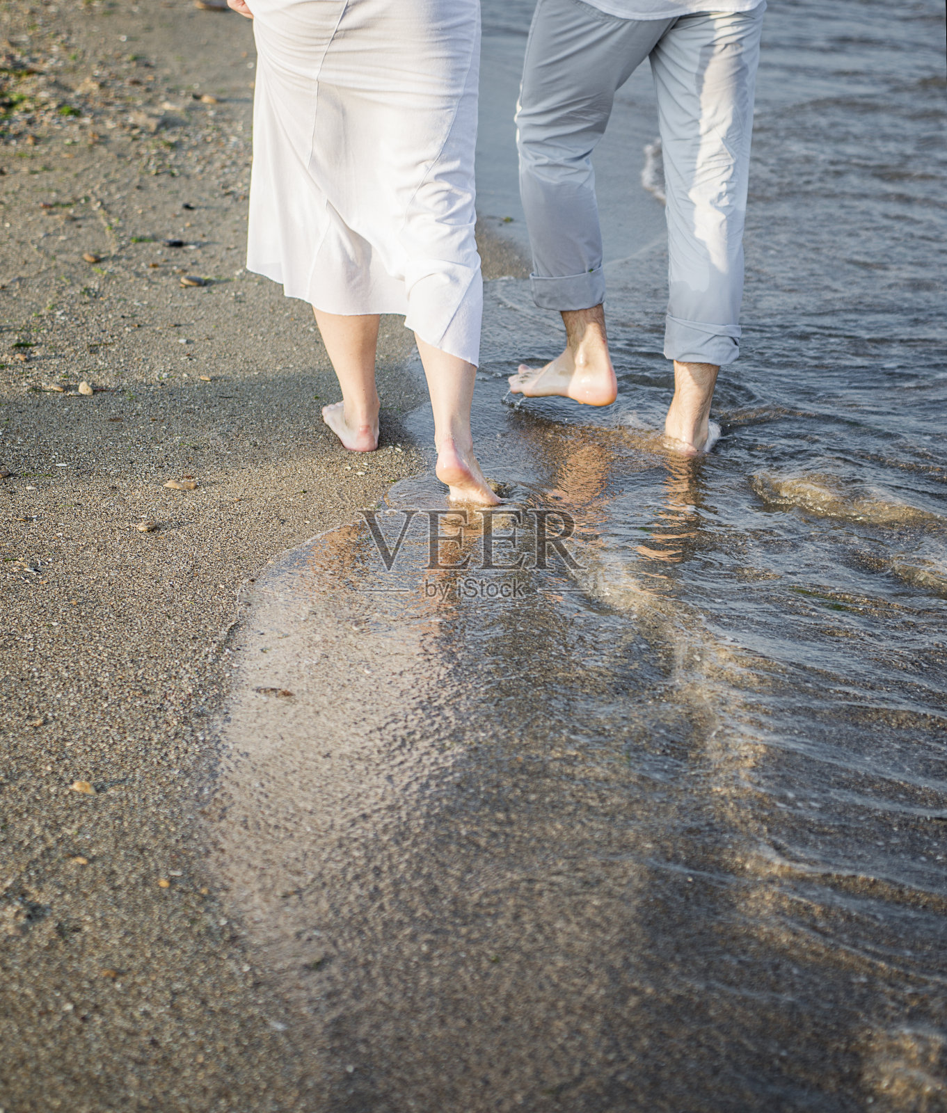 沙滩上一对情侣的腿照片摄影图片