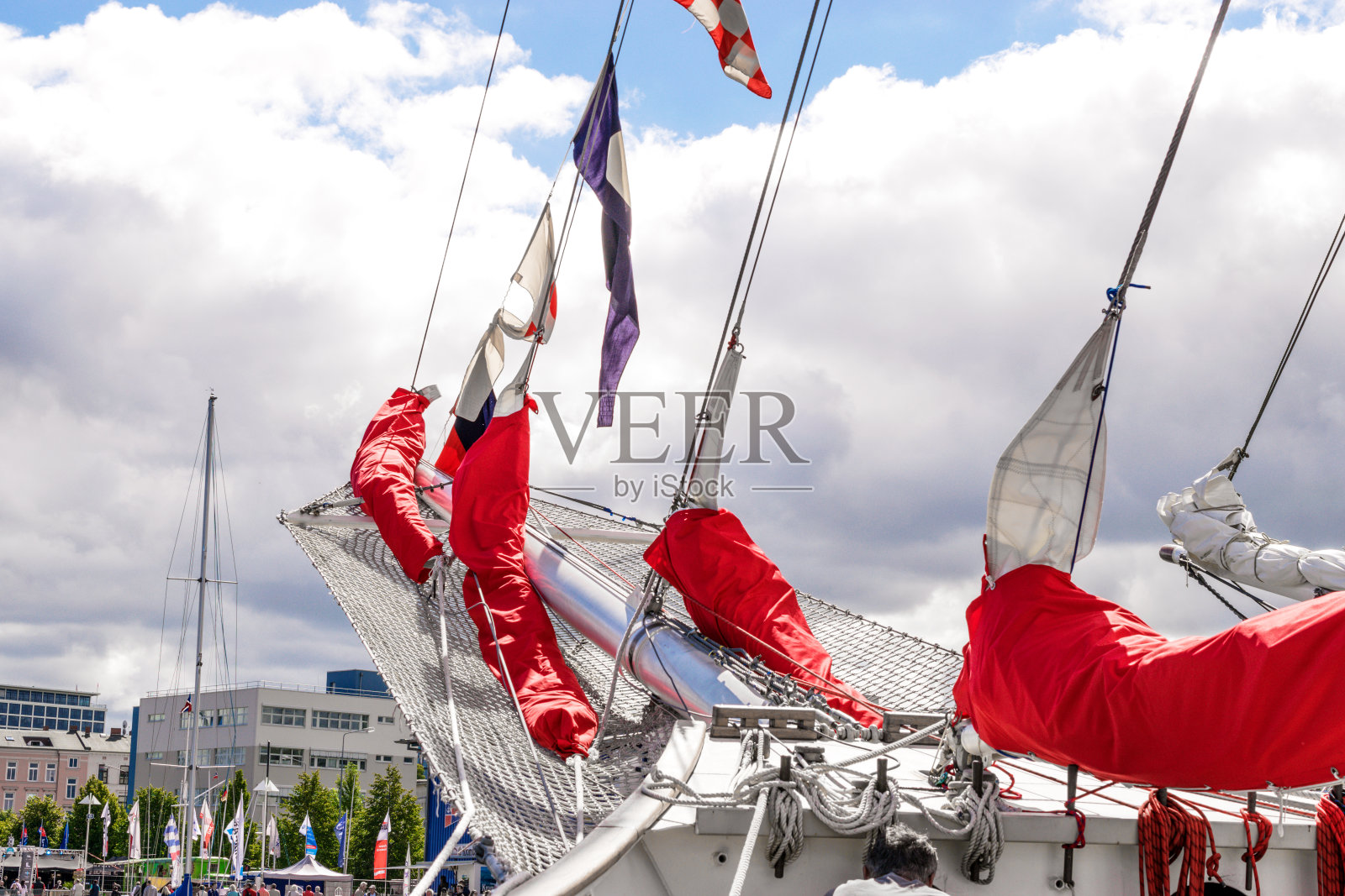船首斜桅，收起了帆船的红帆。照片摄影图片