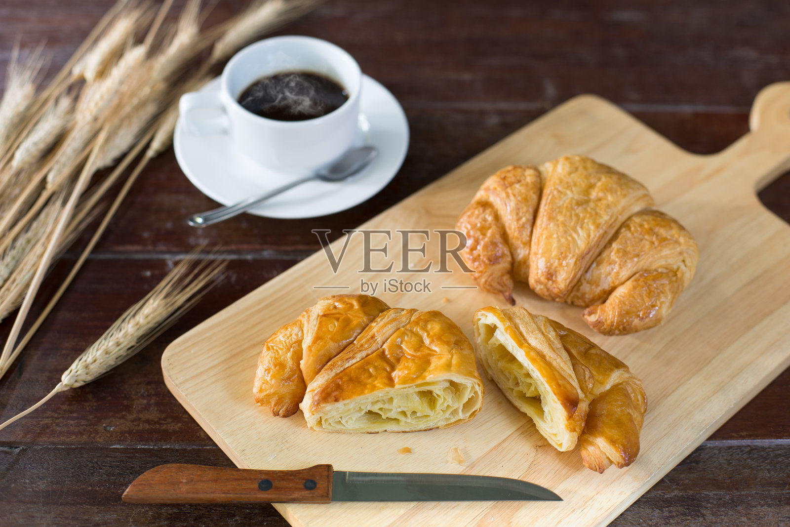 清咖啡和羊角面包，放在劈柴上照片摄影图片