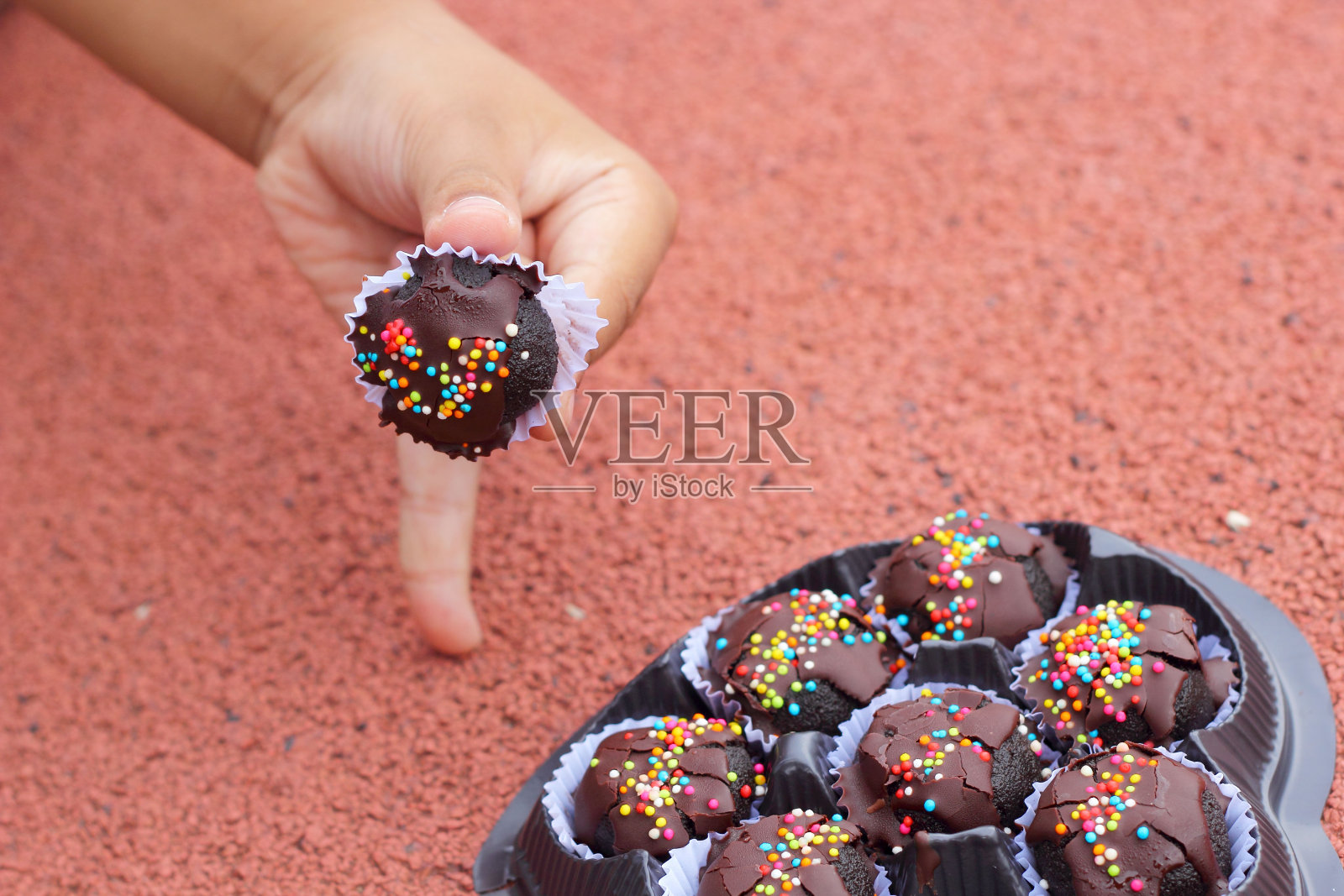 手上的巧克力球。照片摄影图片