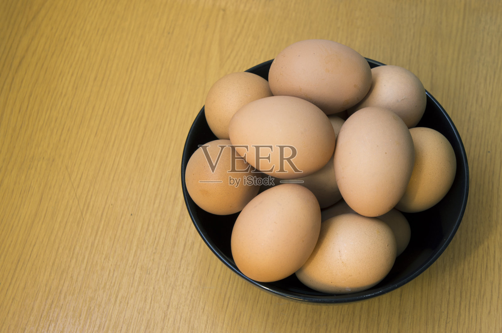 鸡蛋在桌子上的碗里。照片摄影图片