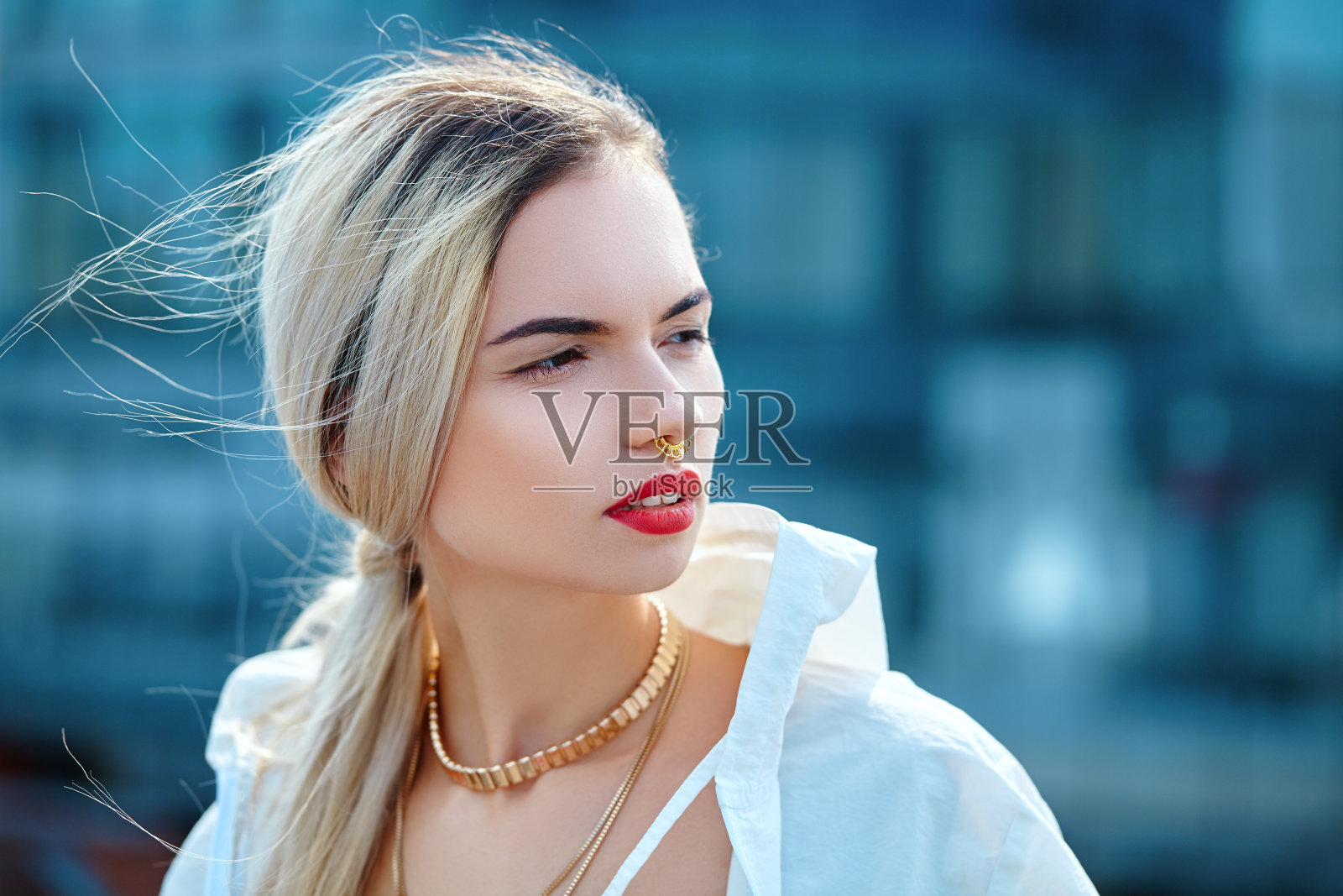 穿着白色风衣的年轻女孩的肖像。照片摄影图片