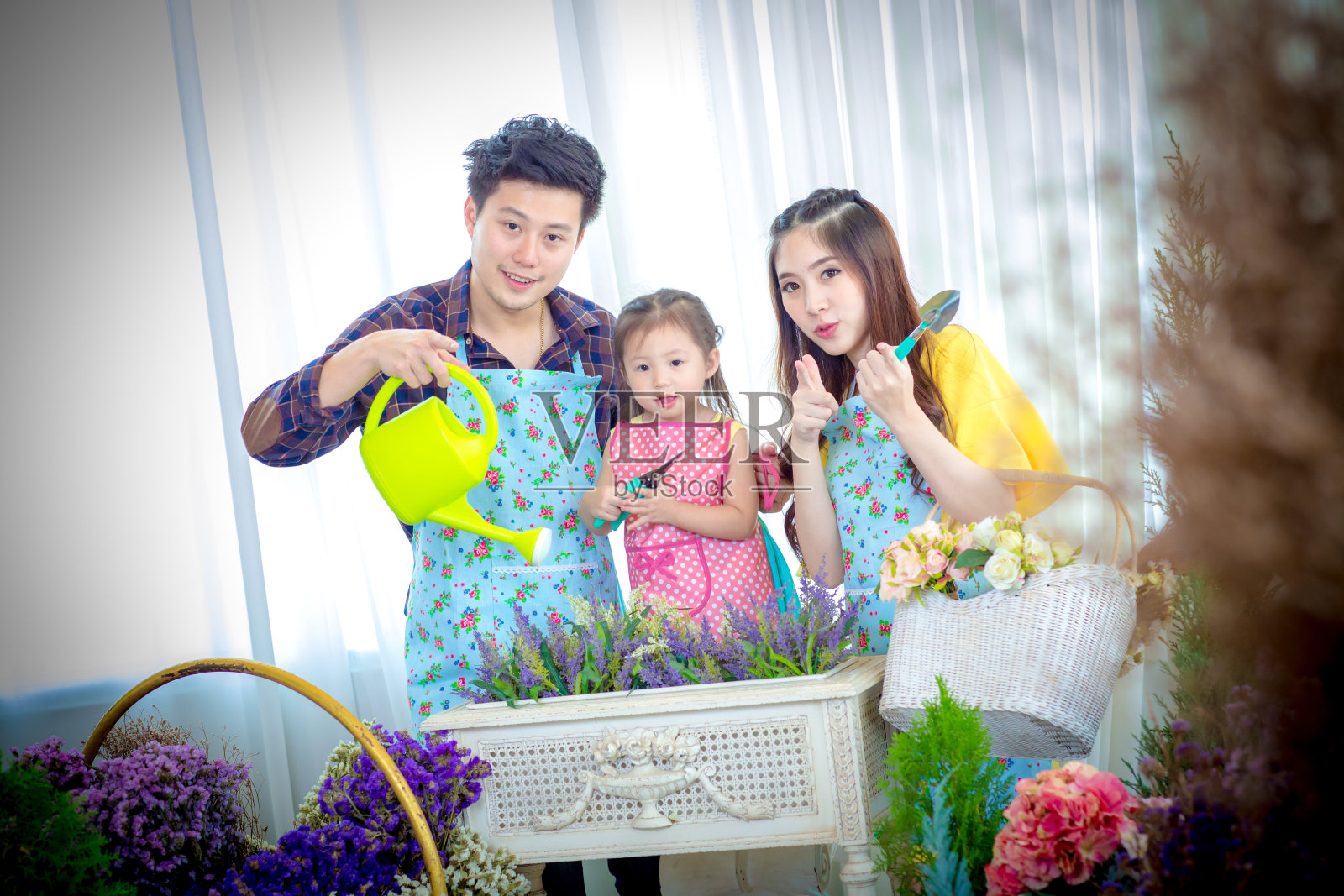 家庭和小女孩在玩园艺。照片摄影图片