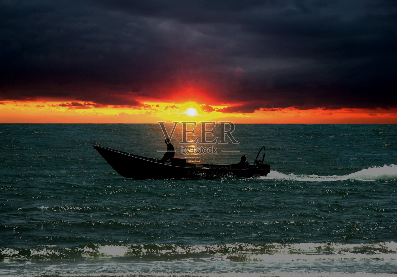 日落时海面上的小船照片摄影图片