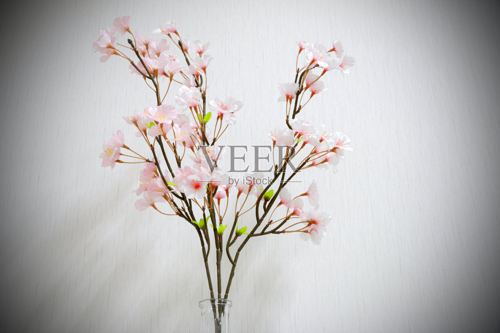 深灰色背景的花瓶里的塑料花照片摄影图片