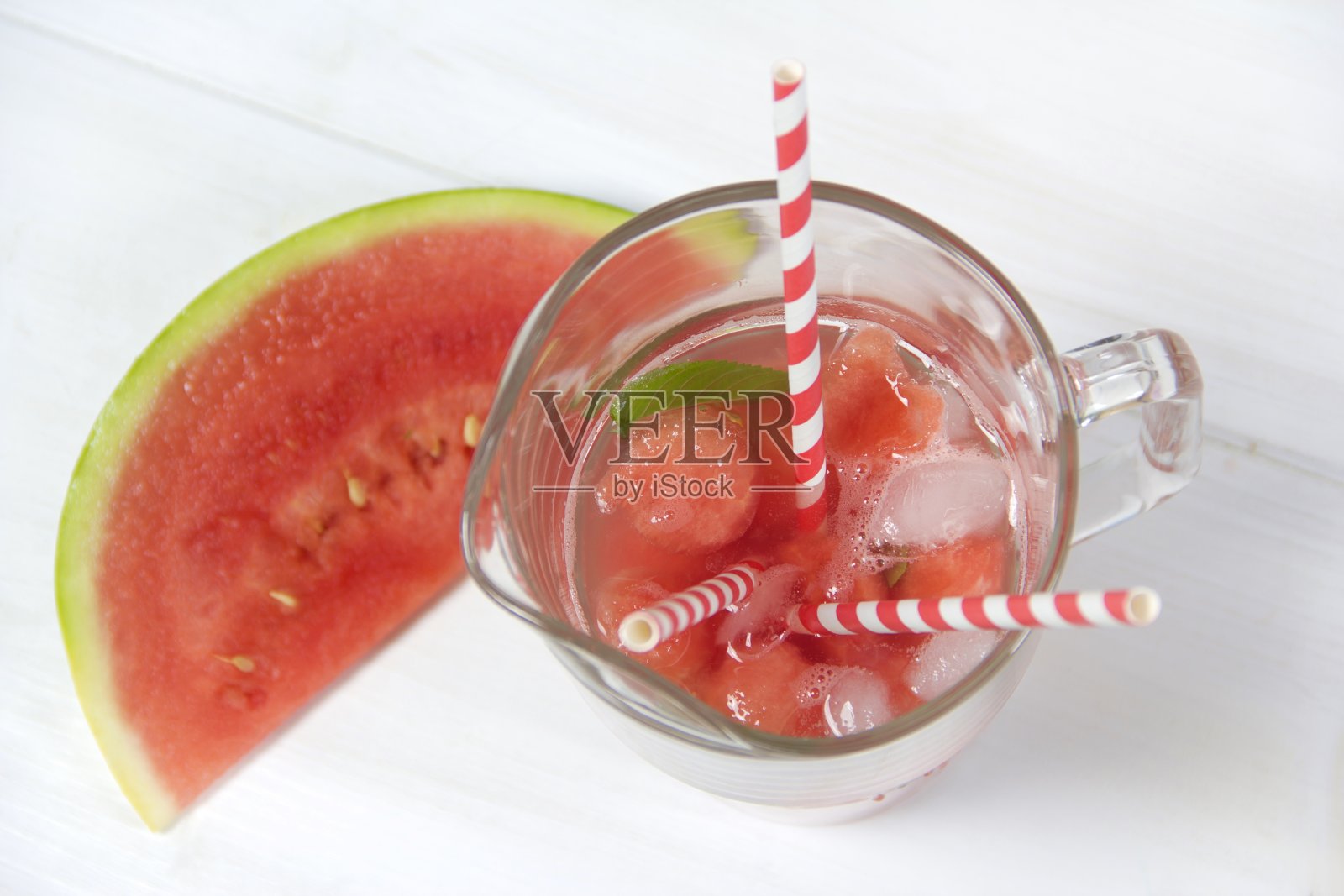 西瓜配草莓糖浆，冰和薄荷叶一起饮用照片摄影图片