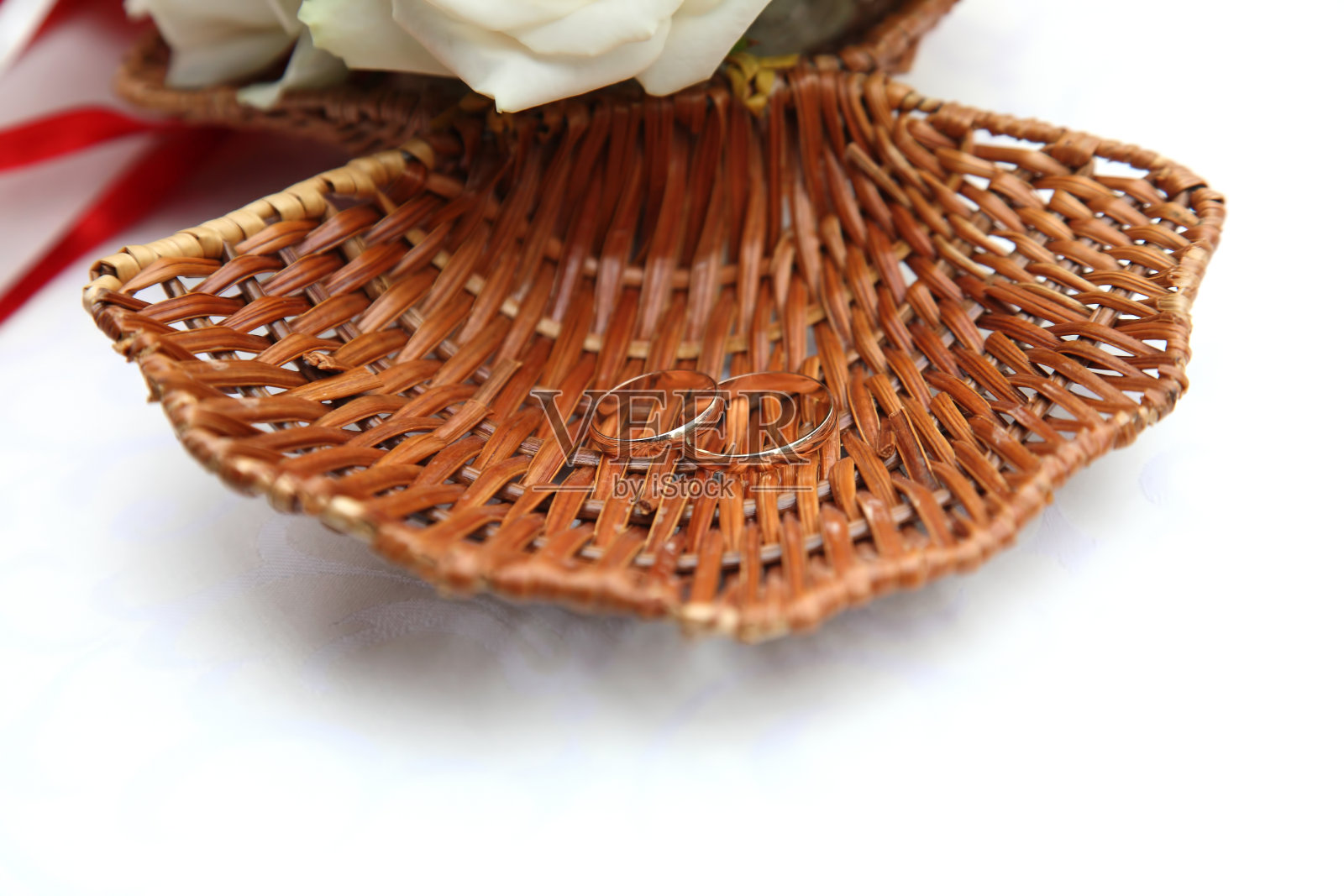 结婚戒指放在柳条盘壳上照片摄影图片