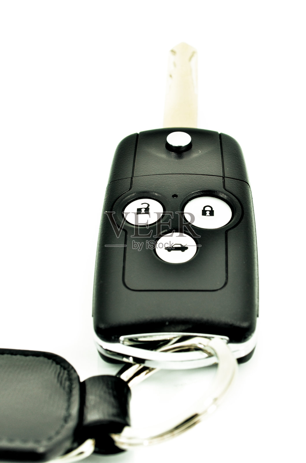 带无线遥控器的汽车钥匙，白色的皮革标签照片摄影图片