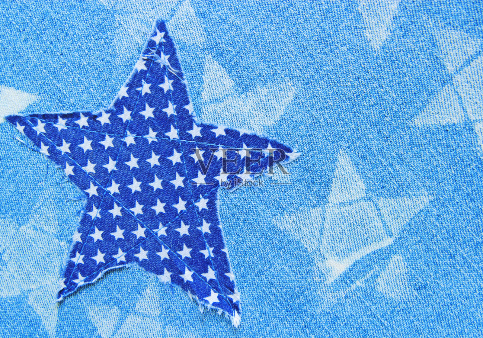 布料牛仔裤上的星形针脚。照片摄影图片