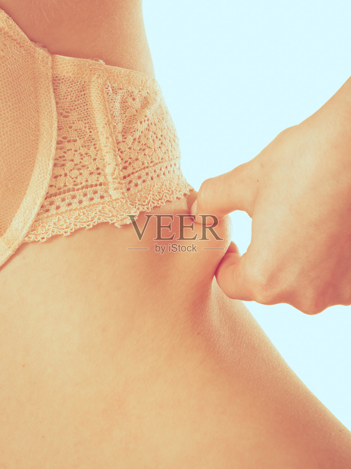 身材苗条的女孩捏着她的肚子。照片摄影图片