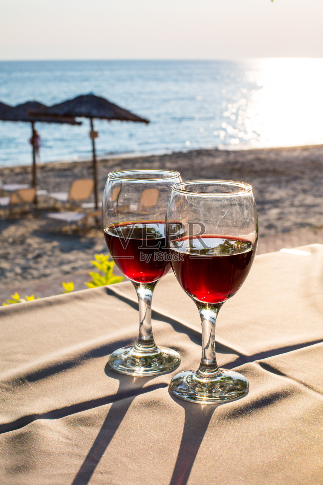 两杯红酒和海滩上的日落照片摄影图片