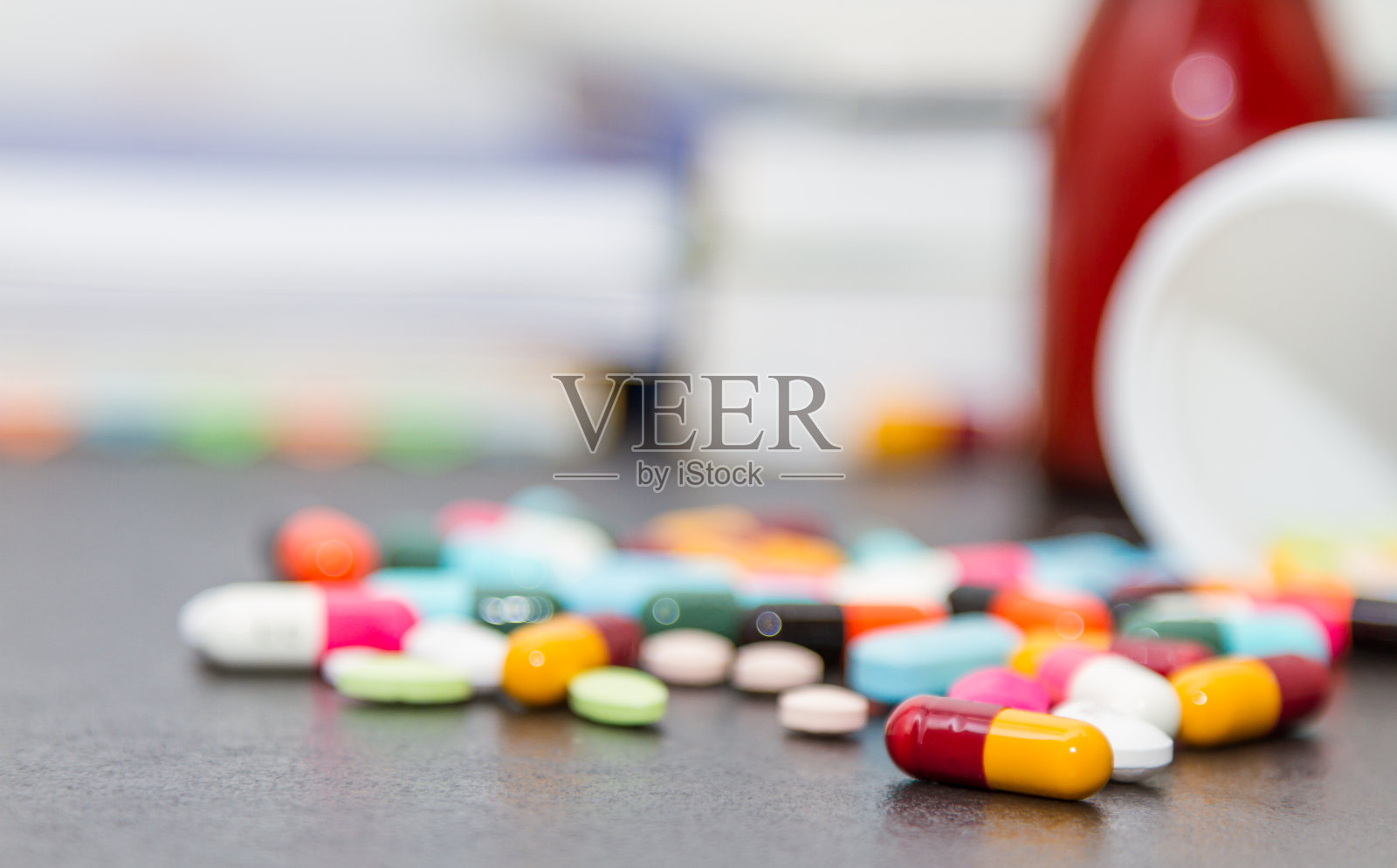 许多药丸和药片在黑色的背景。照片摄影图片