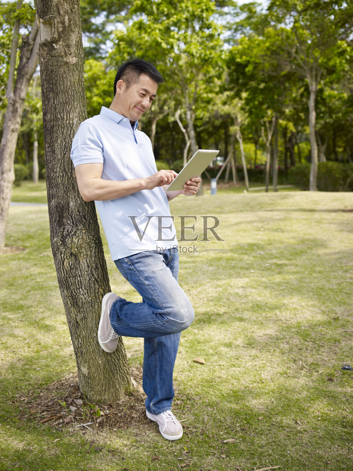 亚洲人在户外使用平板电脑照片摄影图片