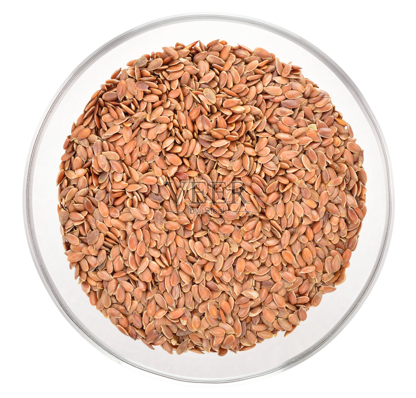 在玻璃碗中分离棕色亚麻籽。照片摄影图片