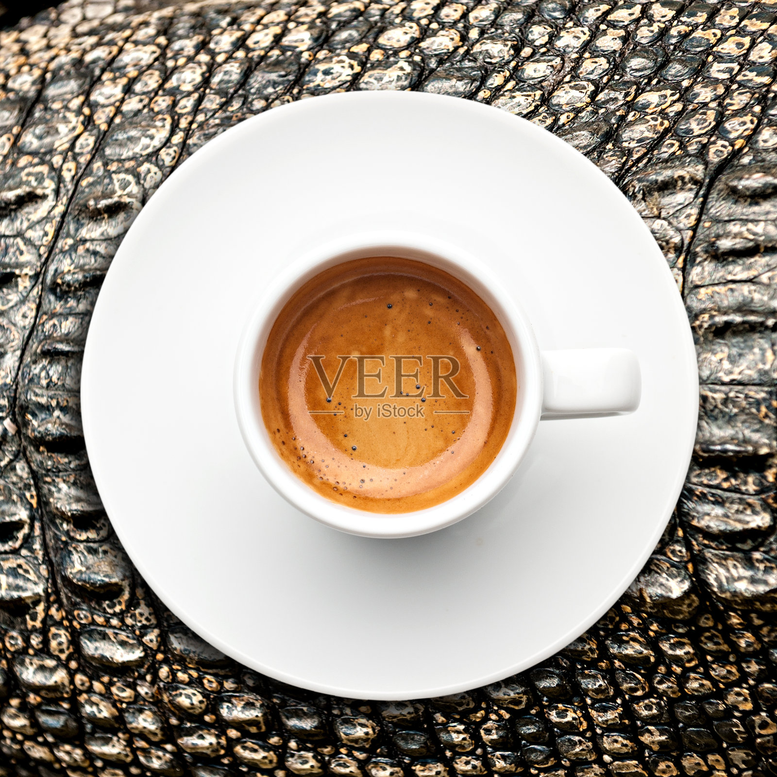 俯视图一杯浓缩咖啡在鳄鱼皮上照片摄影图片