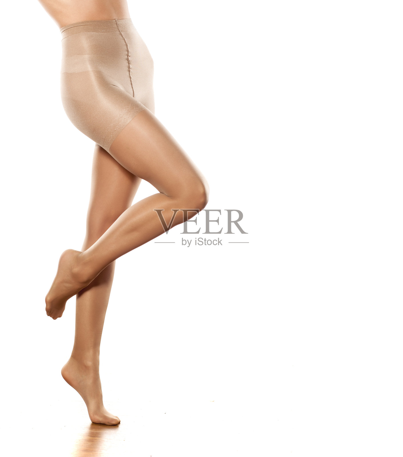 漂亮的女性腿在长袜在一个白色的背景照片摄影图片