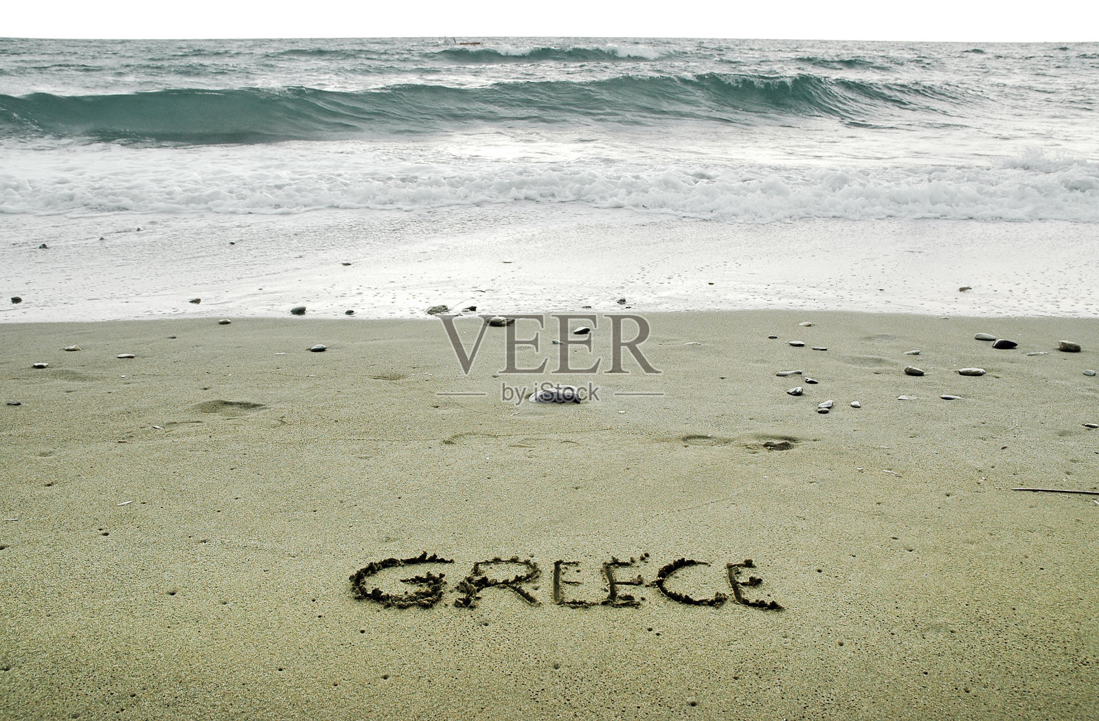 希腊写在沙滩上的沙子上照片摄影图片