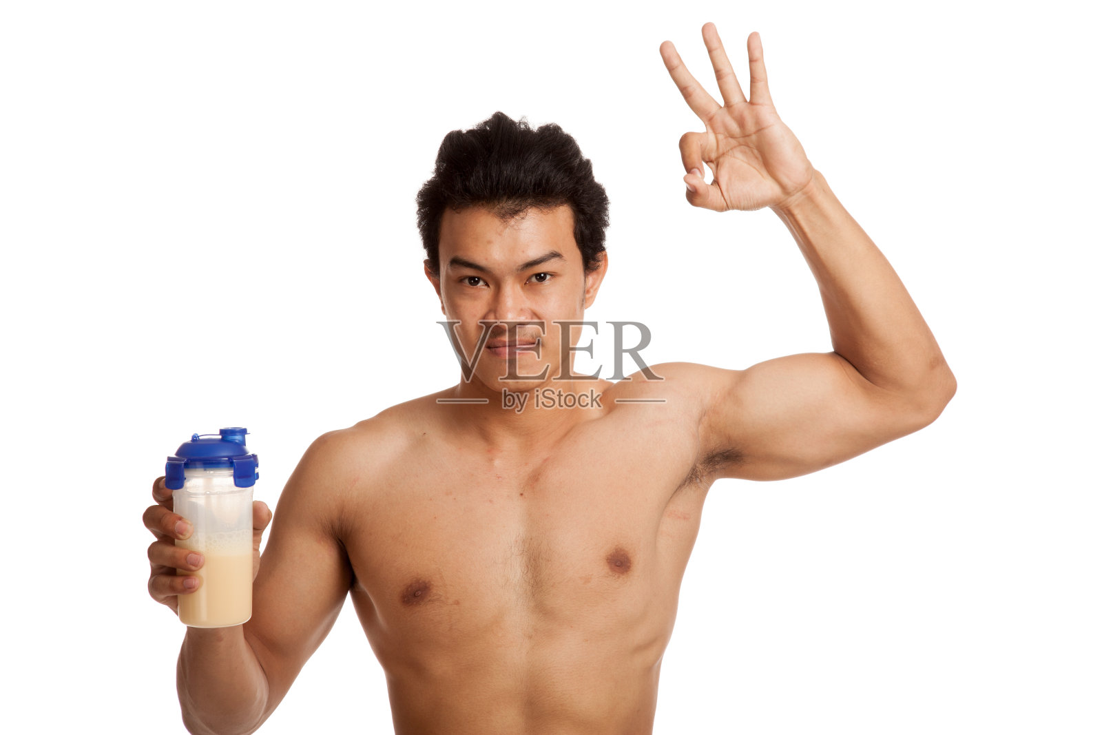 肌肉发达的亚洲男人用乳清蛋白表现OK体征照片摄影图片