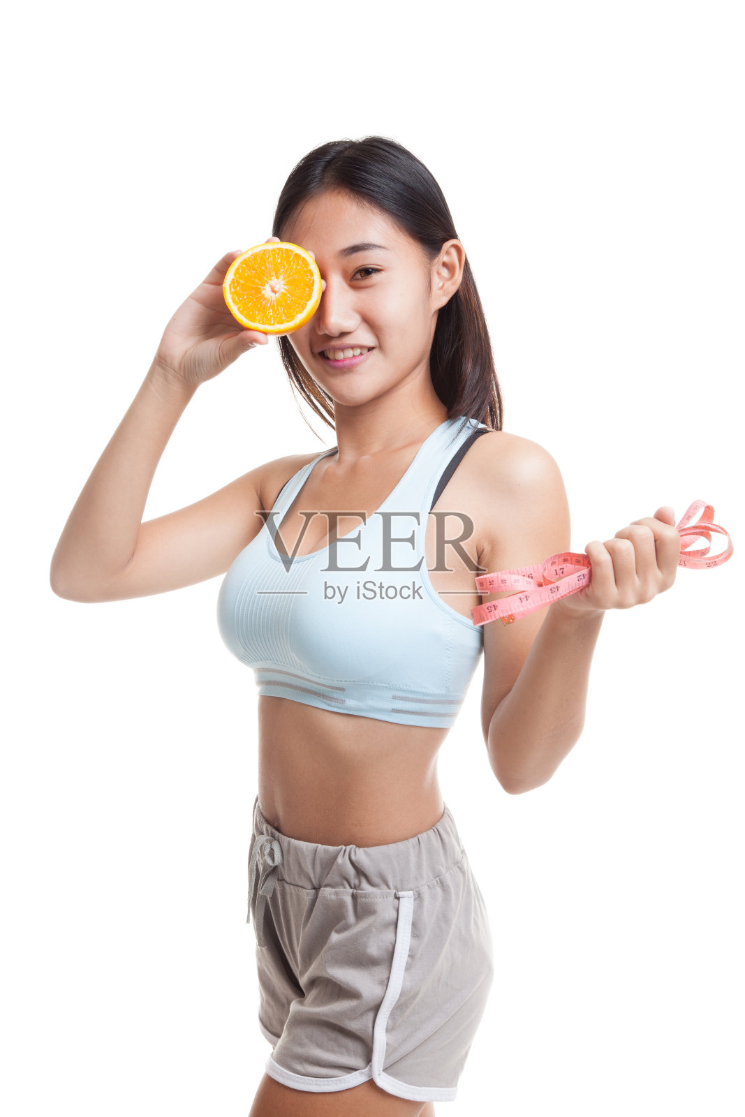 亚洲健康女孩节食与橙水果和测量照片摄影图片
