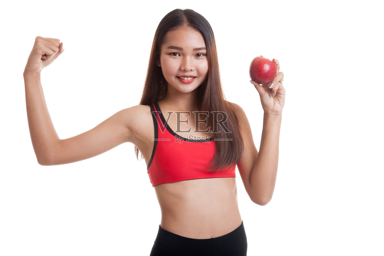 美丽的亚洲健康女孩弯曲与苹果二头肌。照片摄影图片