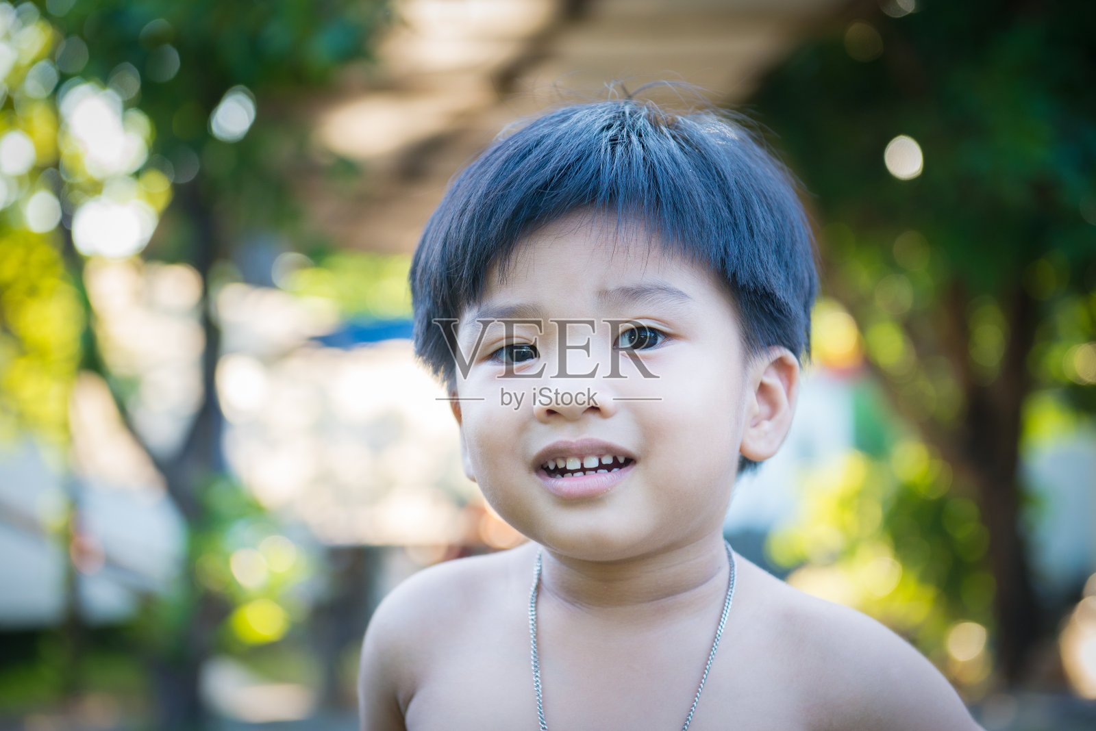 一个亚洲小男孩的户外肖像。照片摄影图片
