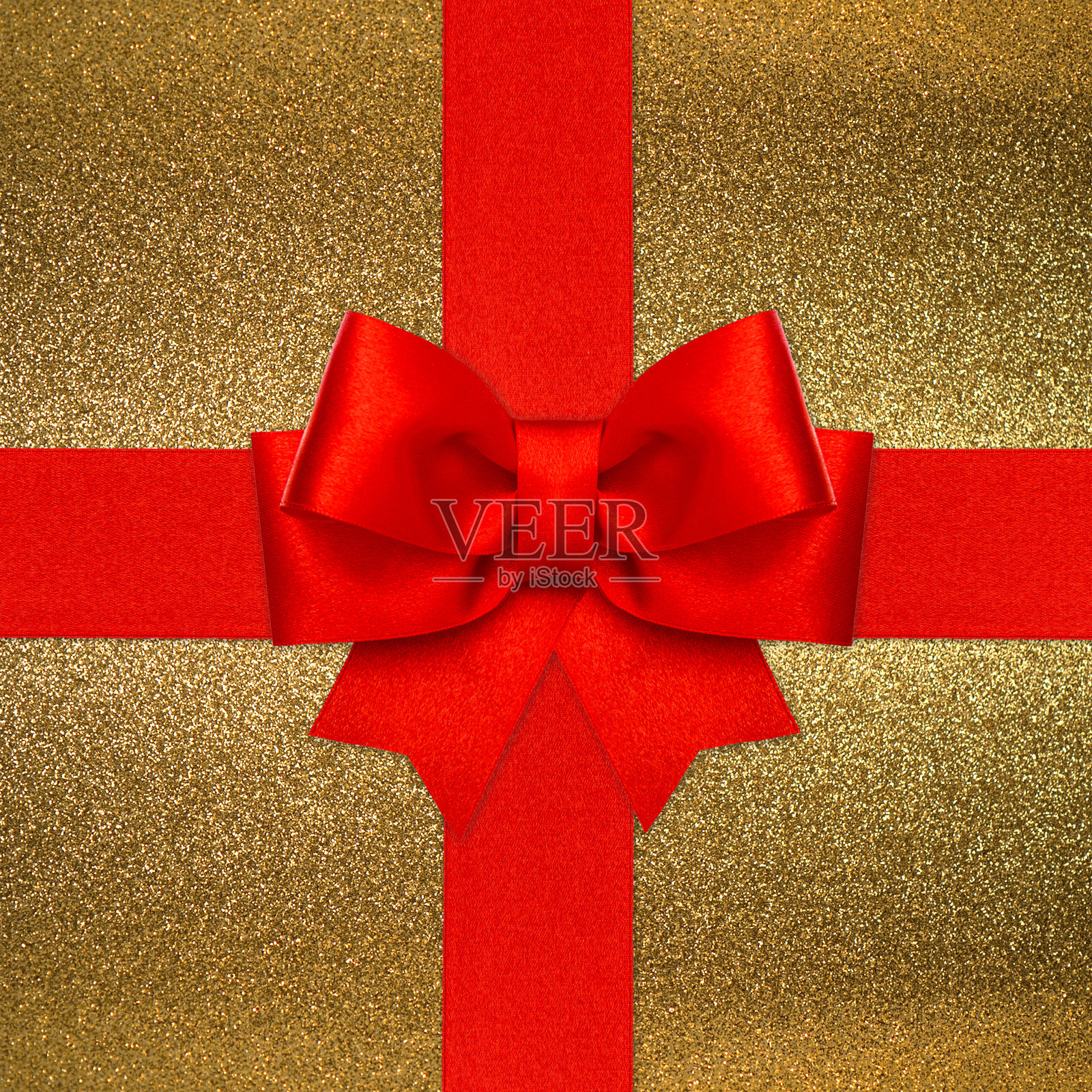 金色背景上的红色蝴蝶结照片摄影图片