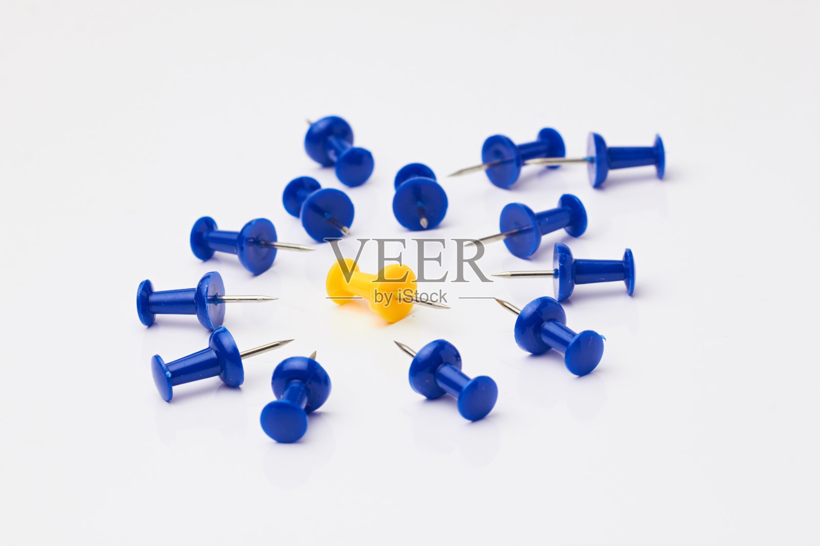 白色背景上的蓝色和黄色图钉。照片摄影图片