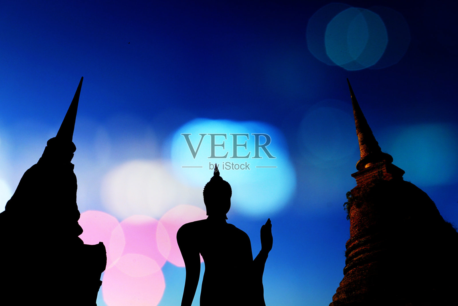 蓝色的天空上，佛像和寺庙的剪影照片摄影图片