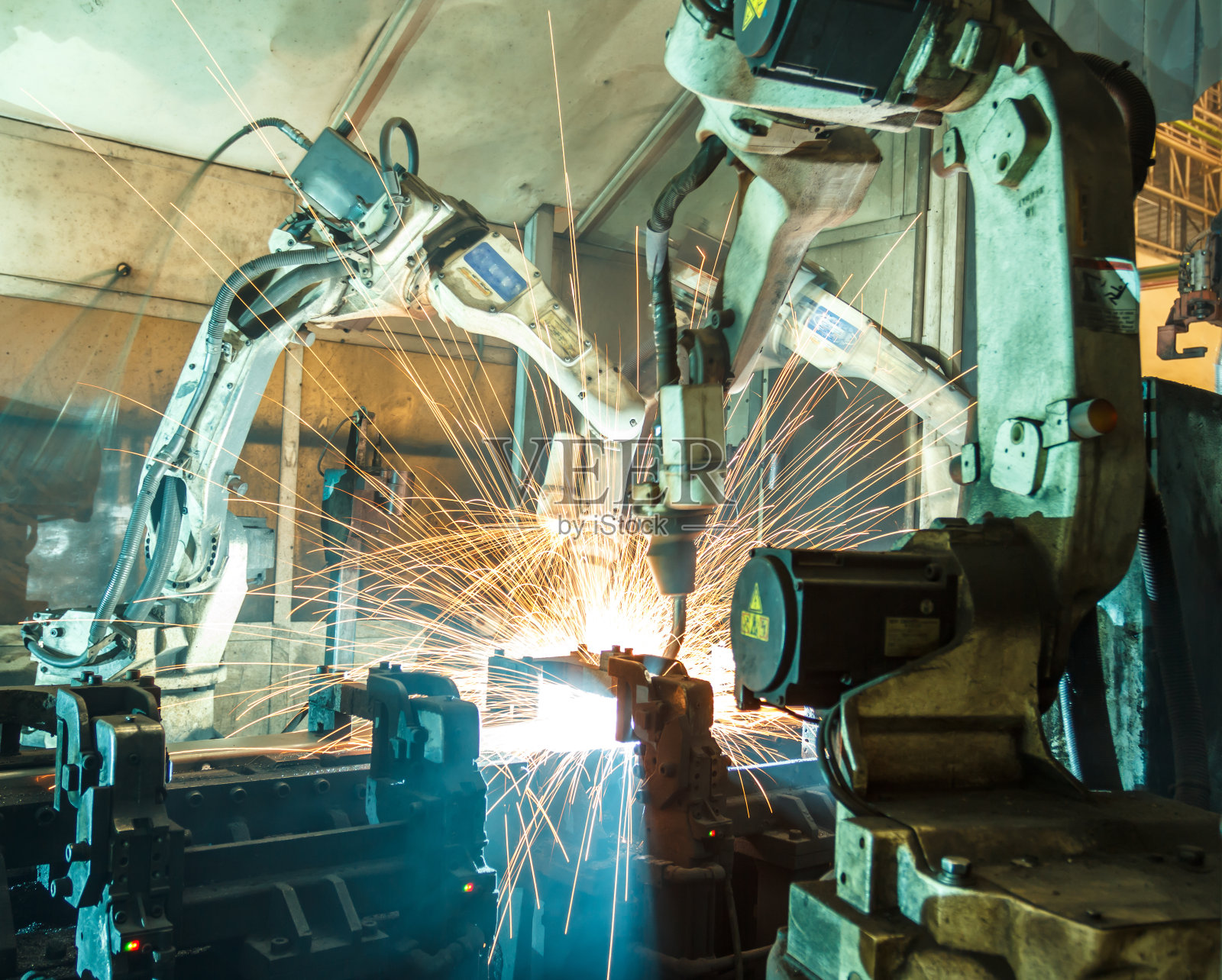 团队机器人焊接钢运动模糊产业。照片摄影图片