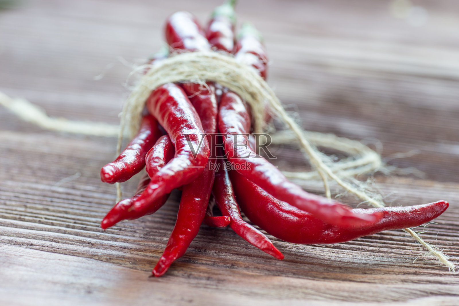 木质背景上的红辣椒。照片摄影图片