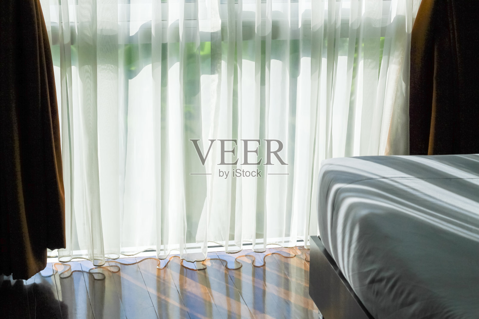 窗帘和阳光溅进卧室。照片摄影图片