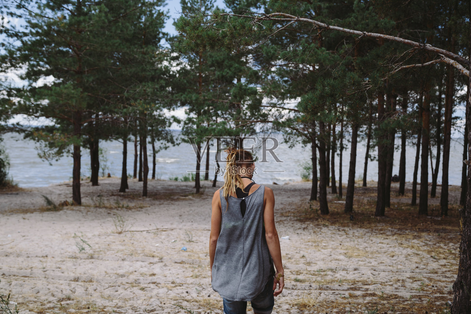欣赏海景的女游客。照片摄影图片