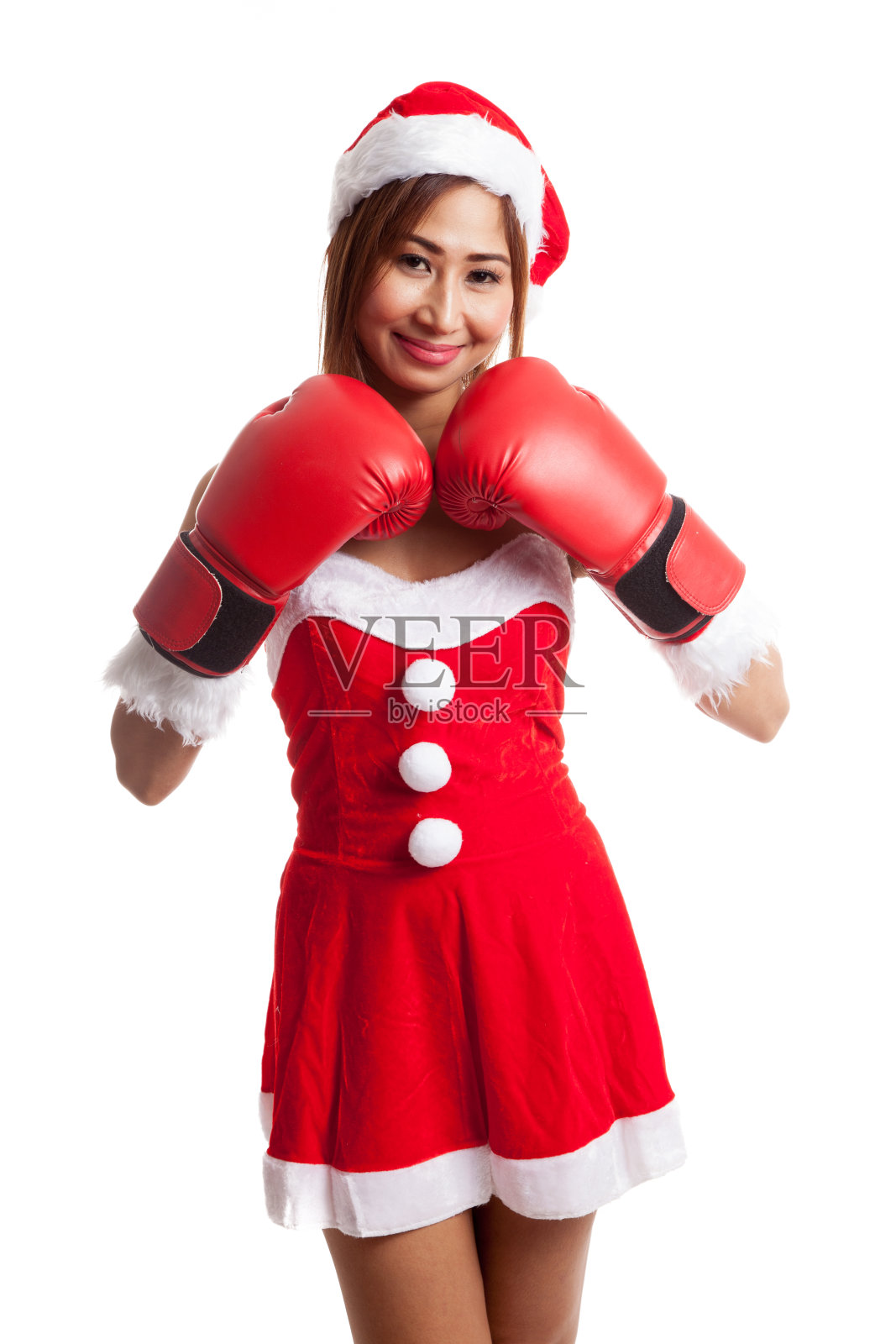 穿着圣诞老人服装和拳击手套的亚洲圣诞女孩照片摄影图片
