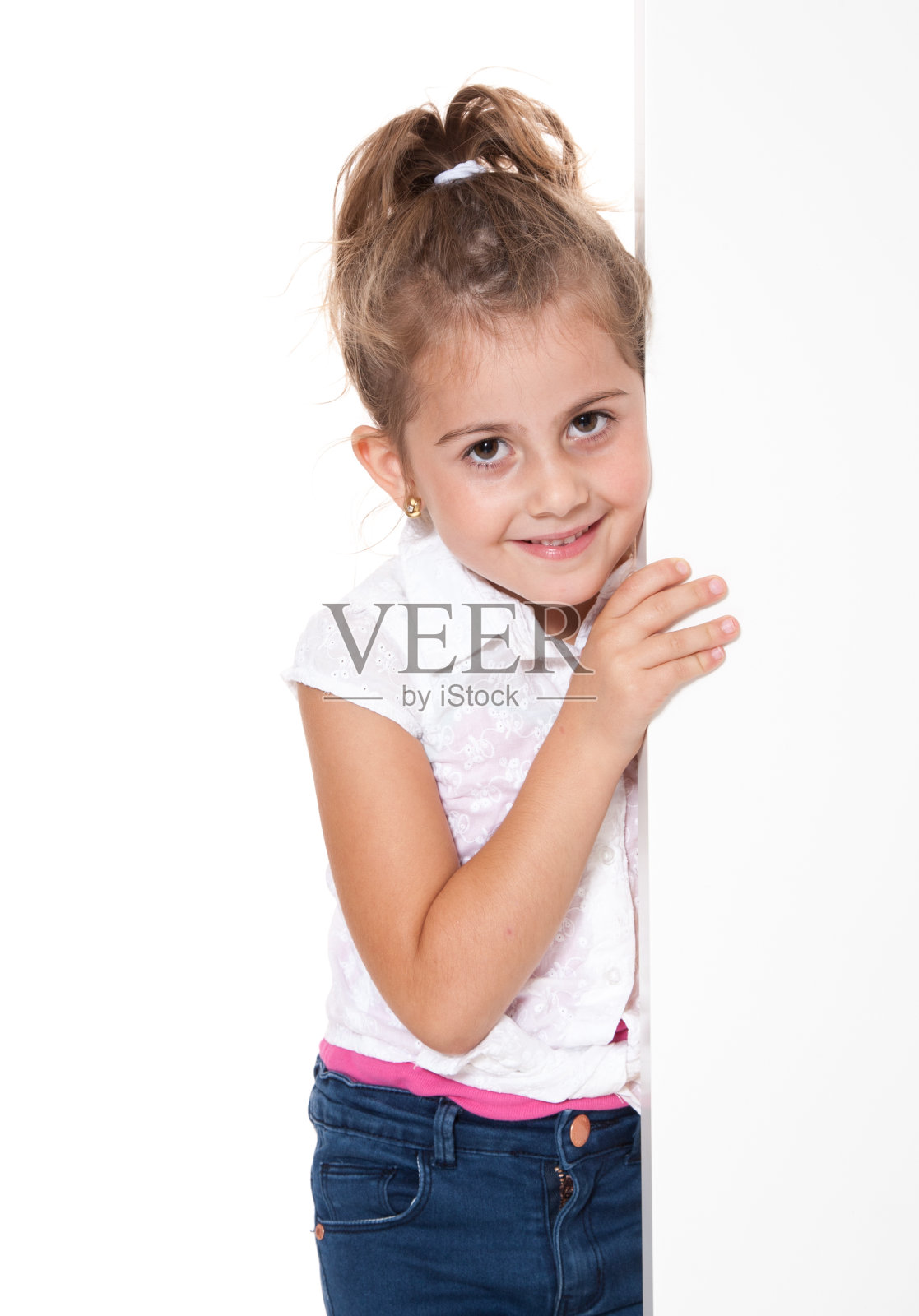 白墙后面的年轻女孩照片摄影图片