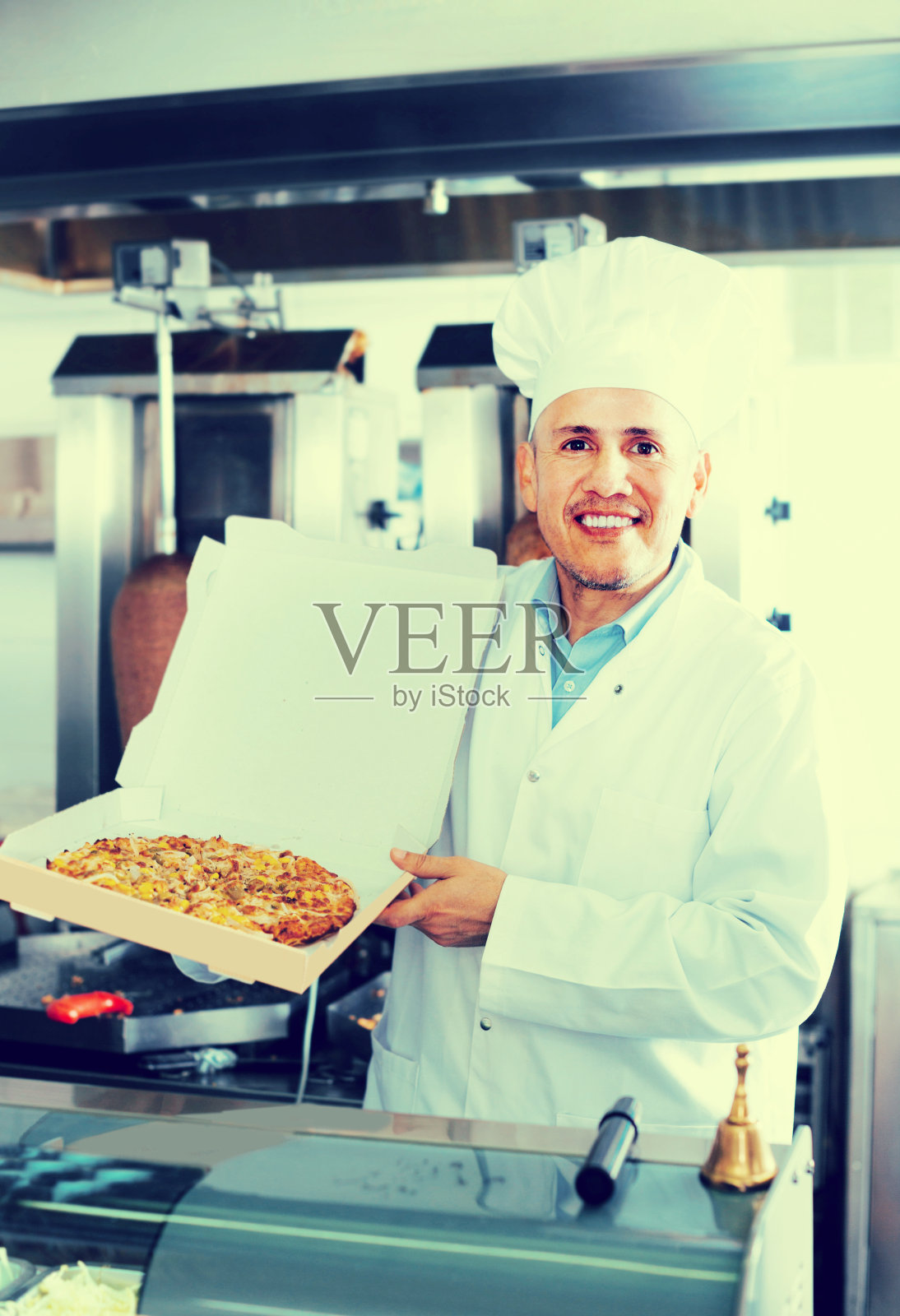 手持披萨的男厨师照片摄影图片